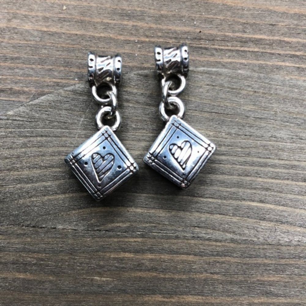 Adorable silver heart dangle earrings.